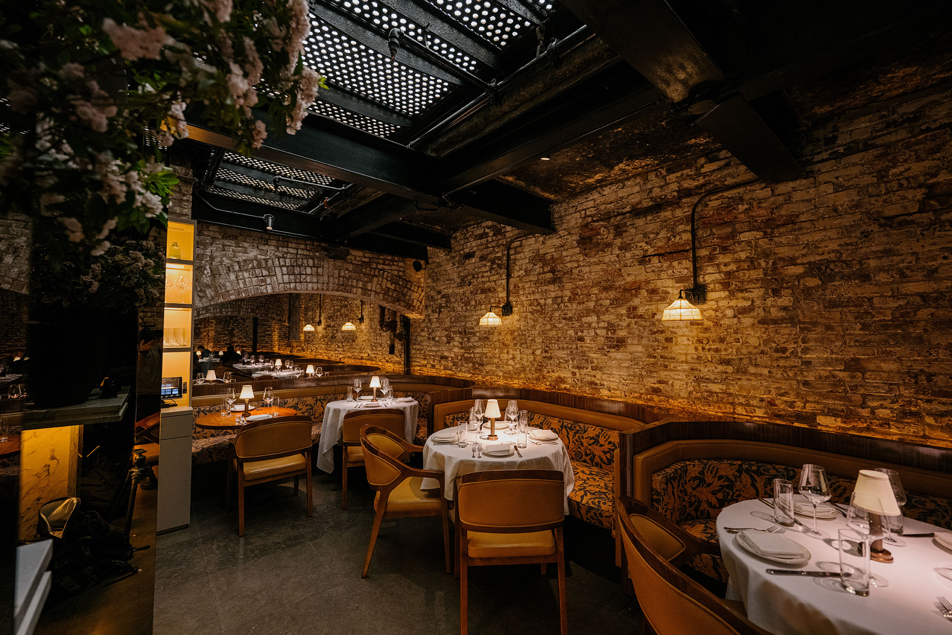 Sartianos Restaurant Seating, banquettes against a brick wall and exposed ceiling at the Mercer Hotel