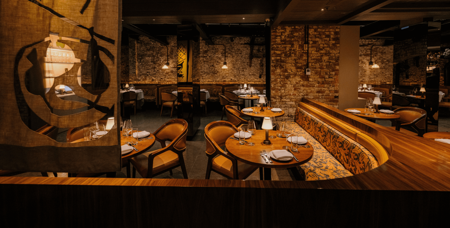 Sartiano's at the Mercer Hotel Dining Room view showing a curved booth and table setup