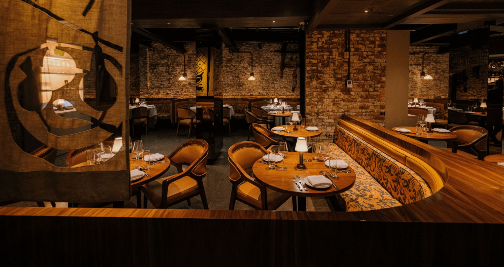 Sartiano's at the Mercer Hotel Dining Room view showing a curved booth and table setup