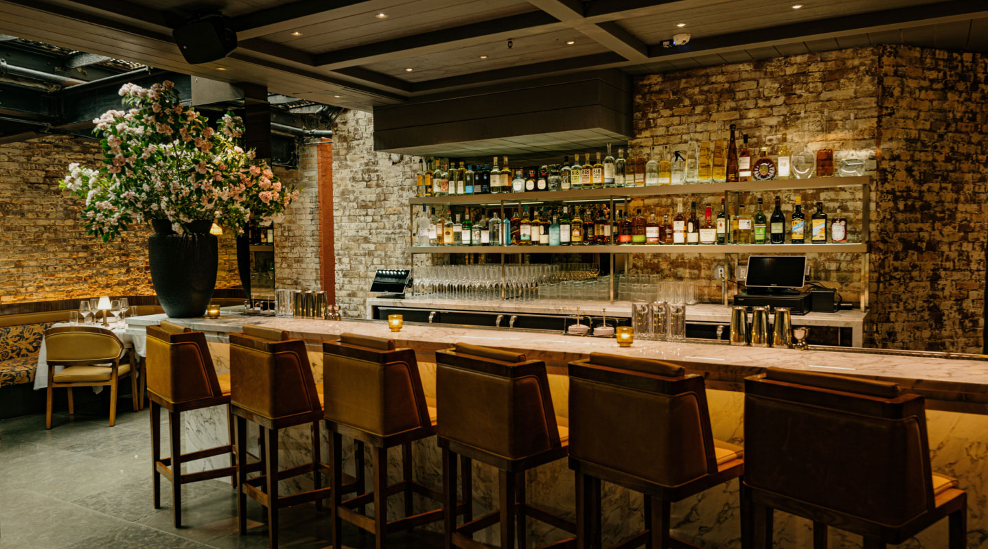 view looking at bar seating inside Sartianos